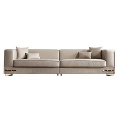 a beige couch with pillows on the back and side ends, in front of a white background