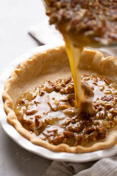 a pie is being drizzled with caramel sauce