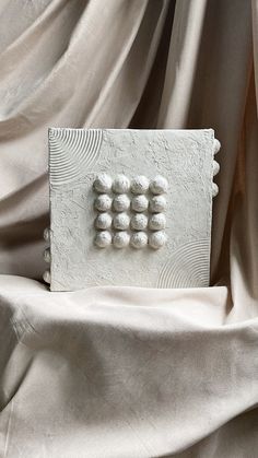 a close up of a white object on a cloth