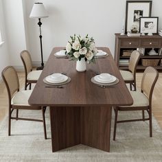 a dining room table with white flowers on it