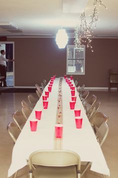 a long table with red cups on it