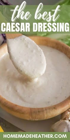 a wooden bowl filled with white sauce and a spoon full of the best caesar dressing