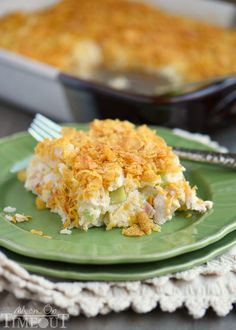 a green plate topped with food next to a casserole dish