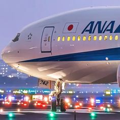 an airplane sitting on the tarmac at night