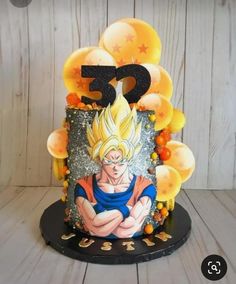 the birthday cake is decorated with balloons and an image of gohan from dragon ball