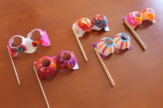 four candy lollipops are sitting on a table