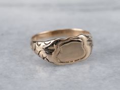 This small Victorian signet ring features engraved curlicues across the shoulders of the piece. This would make an awesome piece for a small, demure pinky ring, a midi ring, or gift for a young girl. Traditionally, this ring was given as a gift for a baby, for the baby's birth or baptism, in the Victorian era.Market Square Jewelers works with one of the finest hand engravers in the northeast. With over 30 years of experience, our engraver hand carves lettering, monograms, crests, or patterns in Rose Gold Top, Gold Shield, Gold Amethyst Ring, Chalcedony Stone, Chalcedony Ring, Personalized Ring, Midi Ring, Signet Rings, Antique Roses