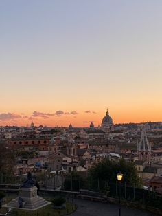 the sun is setting over an old city