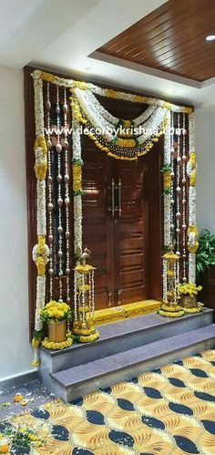 an entrance decorated with flowers and garlands