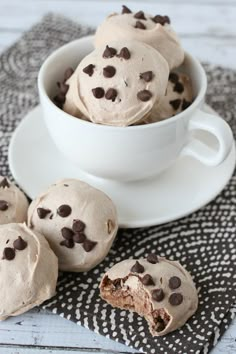 chocolate chip cookie doughnuts in a white bowl on a black and white napkin