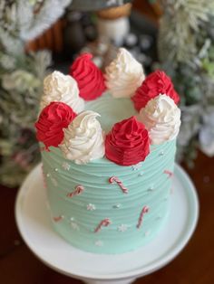 a blue cake with red and white frosting