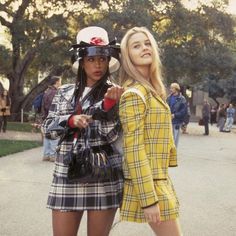 two young women dressed in plaid outfits standing next to each other