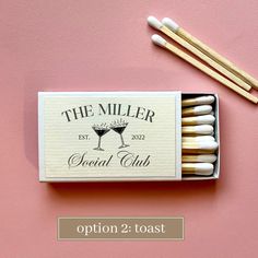 the miller special club matchbox with matches and two wine glasses next to each other