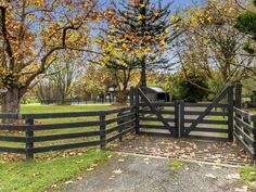 a gated in area with trees and grass