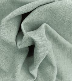 an up close shot of a light green fabric