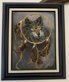 a painting of a dream catcher hanging on the wall