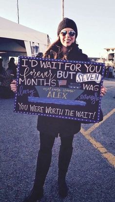 a woman holding up a sign that says i'd wait for you forever but seven years ago