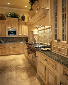 a large kitchen with wooden cabinets and granite counter tops