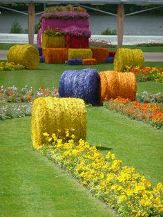 colorful flowers and hay bales in a flower garden