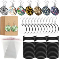 a bunch of earrings are hanging next to each other on a rack and some paper