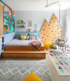 a child's bedroom with colorful walls and artwork on the wall, including a bed