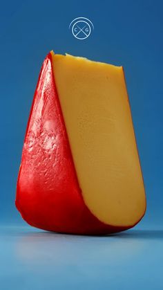 a piece of cheese that has been cut in half and is sitting on a blue surface