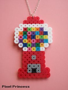 a necklace made out of legos on a pink background with the letter d in it