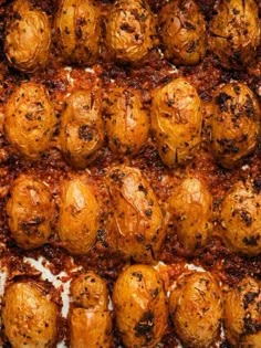 cooked meatballs on a baking sheet covered in sauce