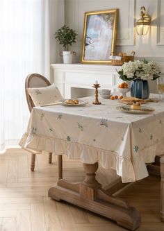 a dining room table covered with a white table cloth