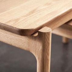 a wooden bench sitting on top of a cement floor