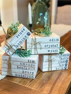 three stacked wooden blocks decorated with dog's names and pine cones tied with twine