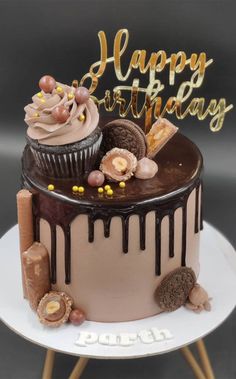 a birthday cake with chocolate frosting and decorations