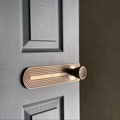 a door handle on the side of a gray door with black and gold trims