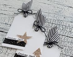 two tags with black and white stripes on them, one has a star in the middle