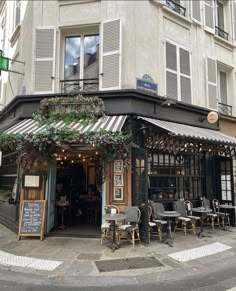 the outside of a restaurant with tables and chairs