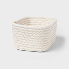 a white woven basket on a grey background