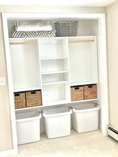 a white closet with baskets and clothes on it