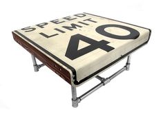 a speed limit sign sitting on top of a metal stand with the words speed limit 40