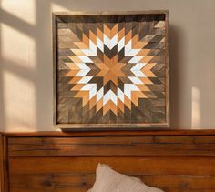 a bed with a wooden headboard and quilt on it