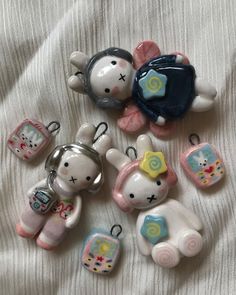 several small animal key chains laying on a bed