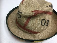 a hat that is sitting on top of a white table with the number twenty five printed on it