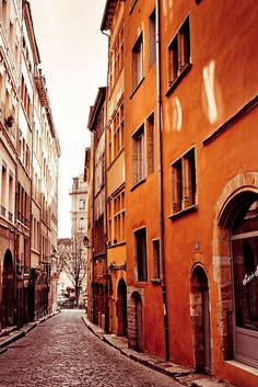 an old cobblestone street with buildings on both sides