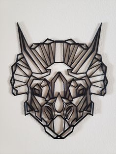 an animal mask made out of metal on a wall