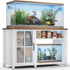 an aquarium with fish and plants in it's display case, on top of a white cabinet