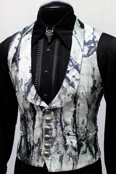 "A classic brocade gambler's vest with a formal style. A men's rich vest in a luxurious unique black/silver/white fabric with a low slung shawl collar and stylish button up front. The vest buttons with six metal lion buttons and has working pockets on either side. The back and inside lining are made in sleek black satin. The sizing is adjustable with a satin belt at the back that can tightened for a tapered fit. Comes in sizes Small to 3X. Magnanimous!! This one is going to sell out fast! Size m Monte Cristo, Designer Suits For Men, Fashion Suits For Men, Mens Fashion Suits, Gothic Outfits, Formal Style, Mens Costumes, Suit Fashion, Ladies Dress Design