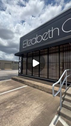 an empty parking lot with stairs leading up to the storefront and door that says elizabeth court