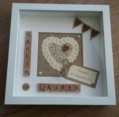 a wooden frame with some scrabbles in it and a heart on the inside