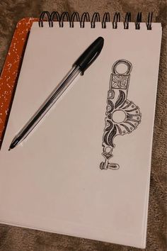 a notebook with a pen on top of it