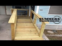 a wooden porch with steps leading to the front door and back deck that has a sign saying summer's woodworking on it