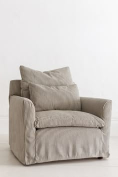 a striped chair sitting in front of a white wall